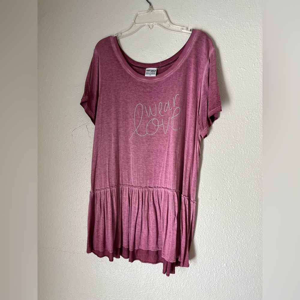 Women’s flowy pink blouse with ruffles at bottom